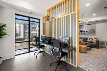 Resident co-working lounge with coffee bar and business center with pcs and wireless printing